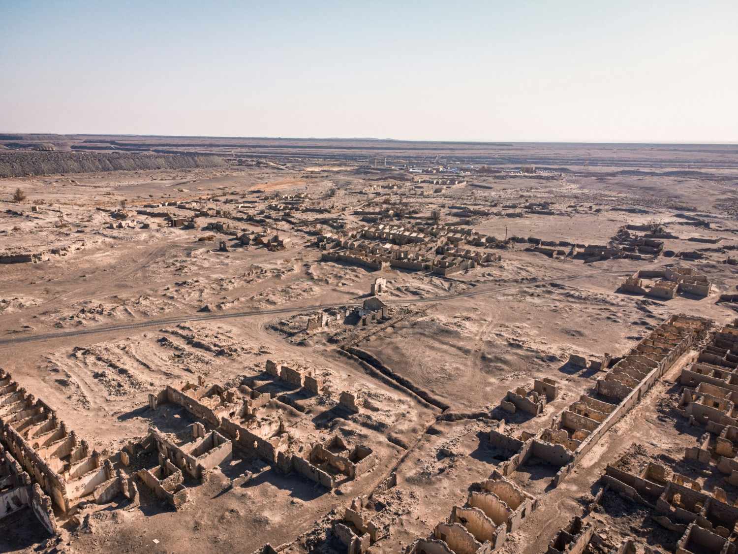 Aerial view of the entire Giza pyramid complex showing the three main pyramids, sphinx, and surrounding archaeological sites