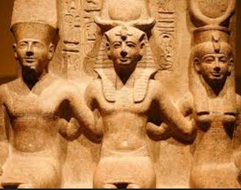 Ancient Egyptian pharaoh statue showing traditional royal regalia, crown, and symbolic elements of divine kingship