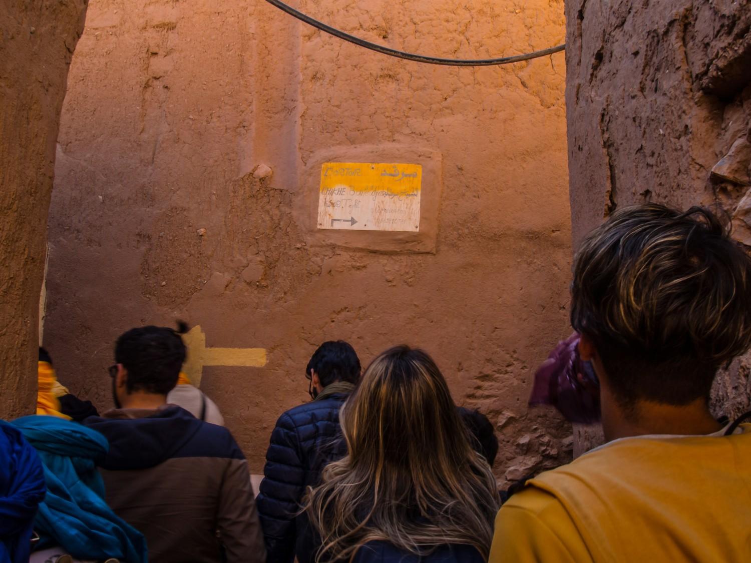 Visitors inside the Great Pyramid chamber with guide explaining ancient burial chamber architecture and hieroglyphics