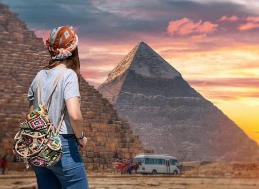 Essential travel items laid out including sun hat, water bottle, comfortable shoes, camera, and sun protection for pyramid visits