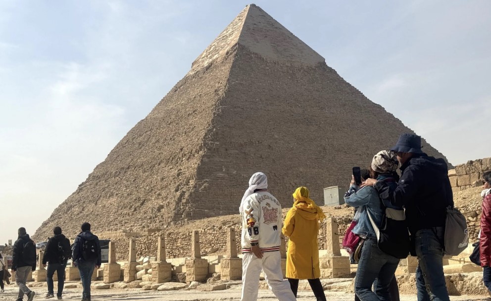 Tourists dressed appropriately and showing respectful behavior while visiting the sacred pyramid sites